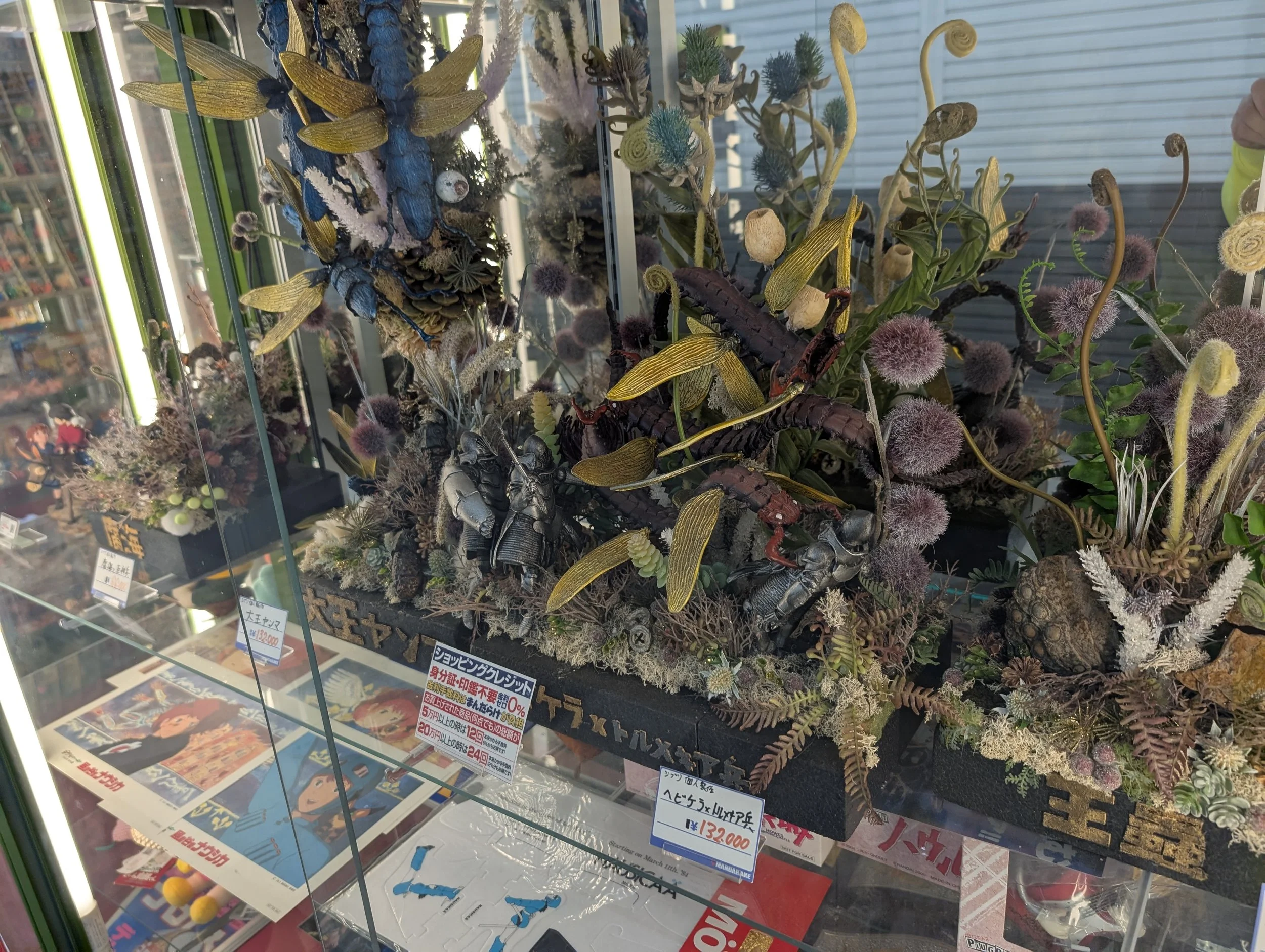 Collectible figures displayed behind glass.