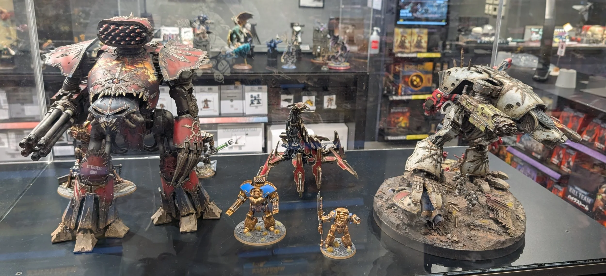 Painted Warhammer models displayed inside the Tokyo cafe.