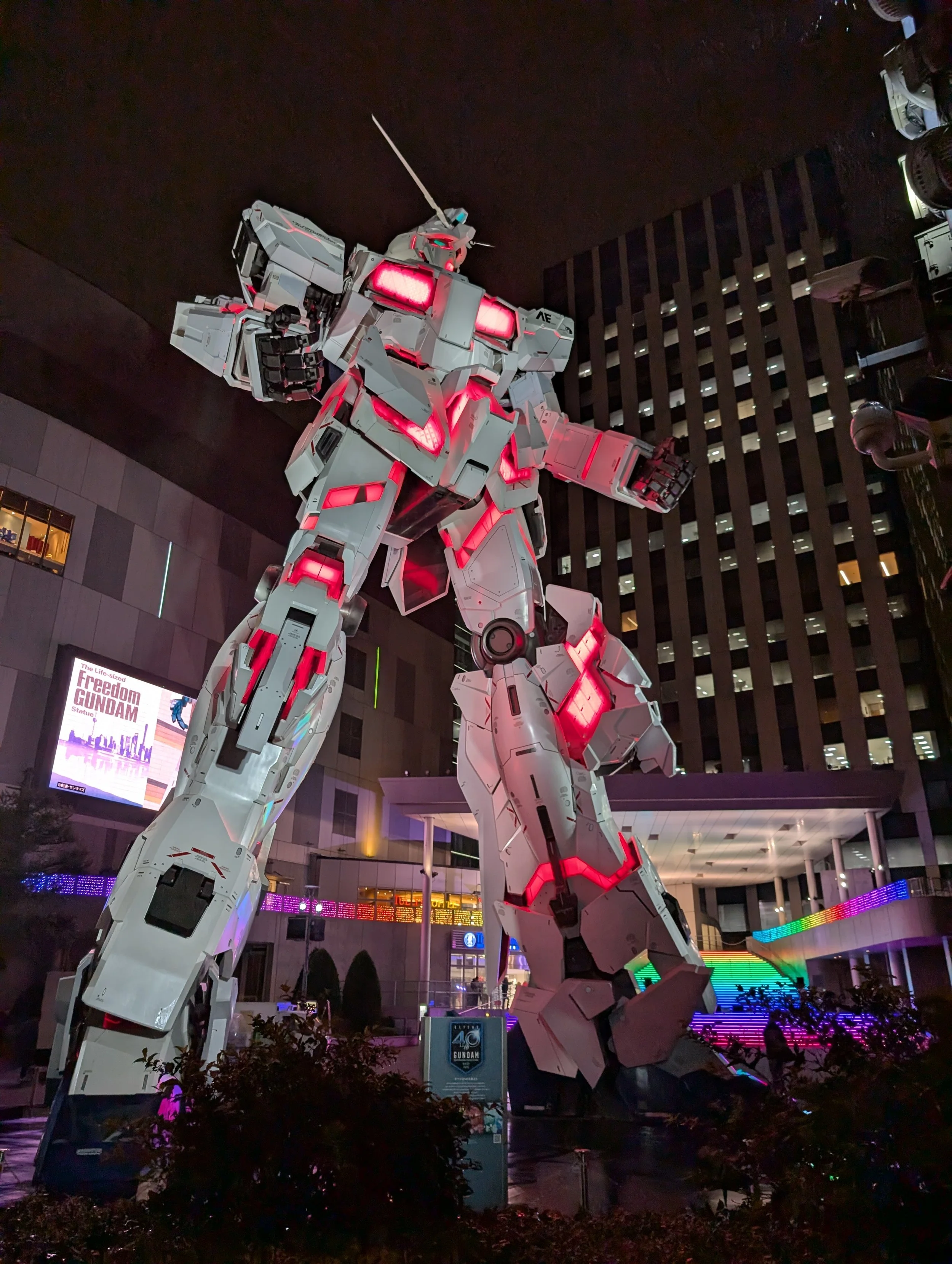 The life-sized Unicorn Gundam statue lit up outside DiverCity Tokyo Plaza.