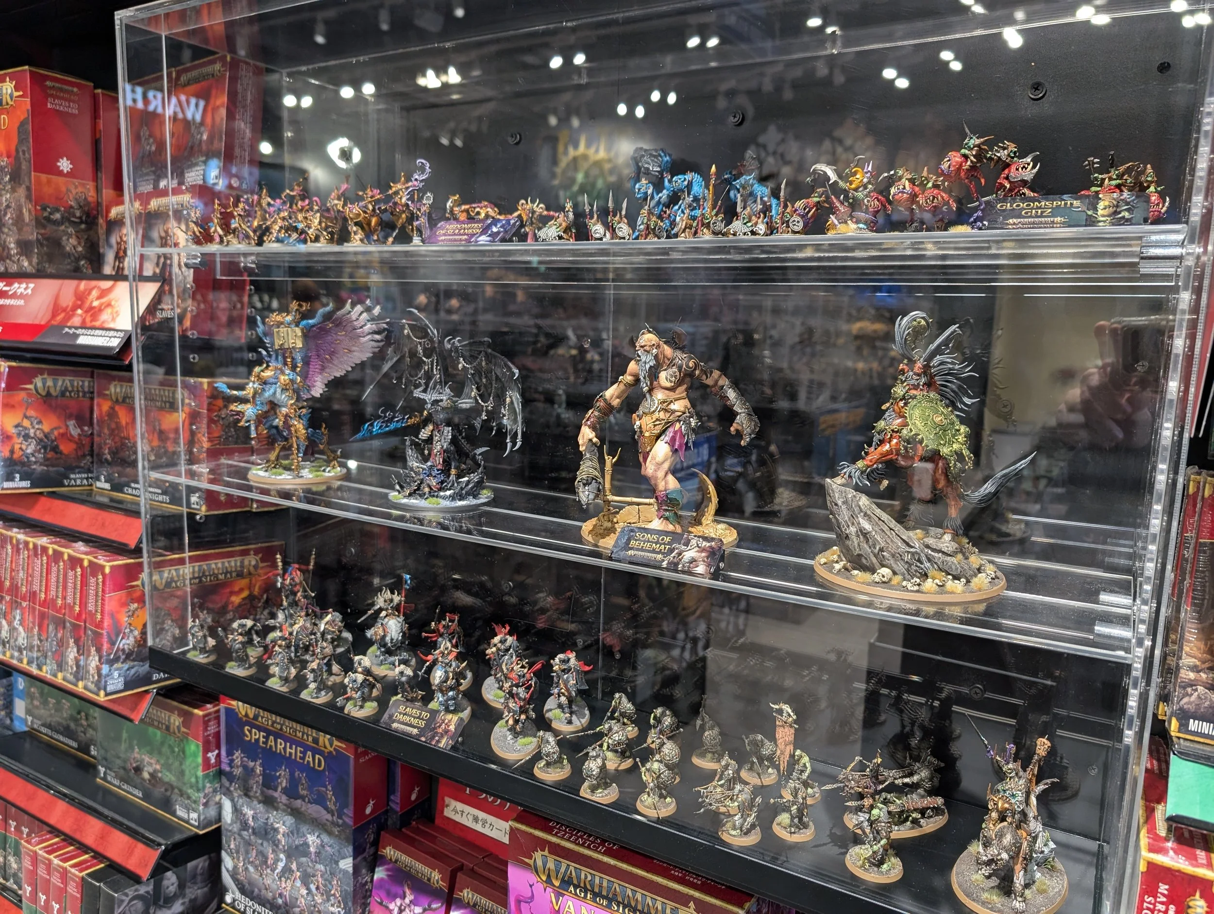 A painted Warhammer miniature display in the cafe.