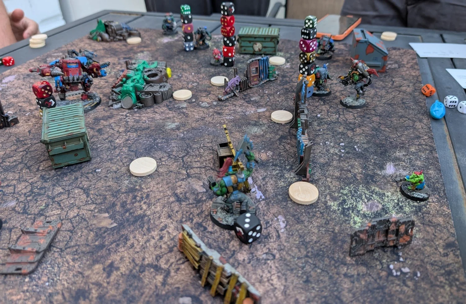 Space Gits warbands spread across a cracked-earth mat, several orks carrying tall stacks of dice on their bases.