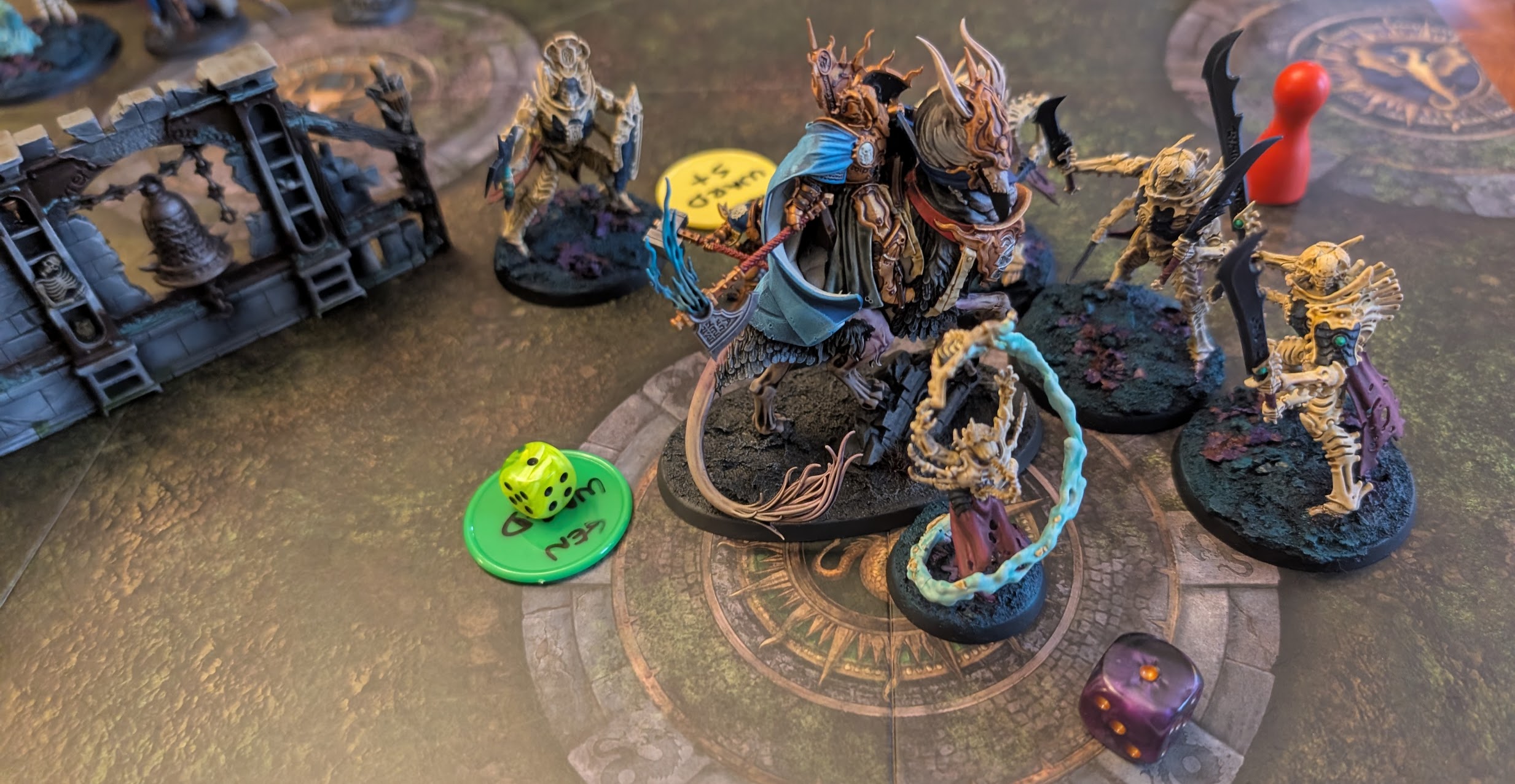 Bonereaper miniatures on a Spearhead board: a bone-armoured lord on a skeletal steed surrounded by skeleton warriors, with ward-save tokens beside them.
