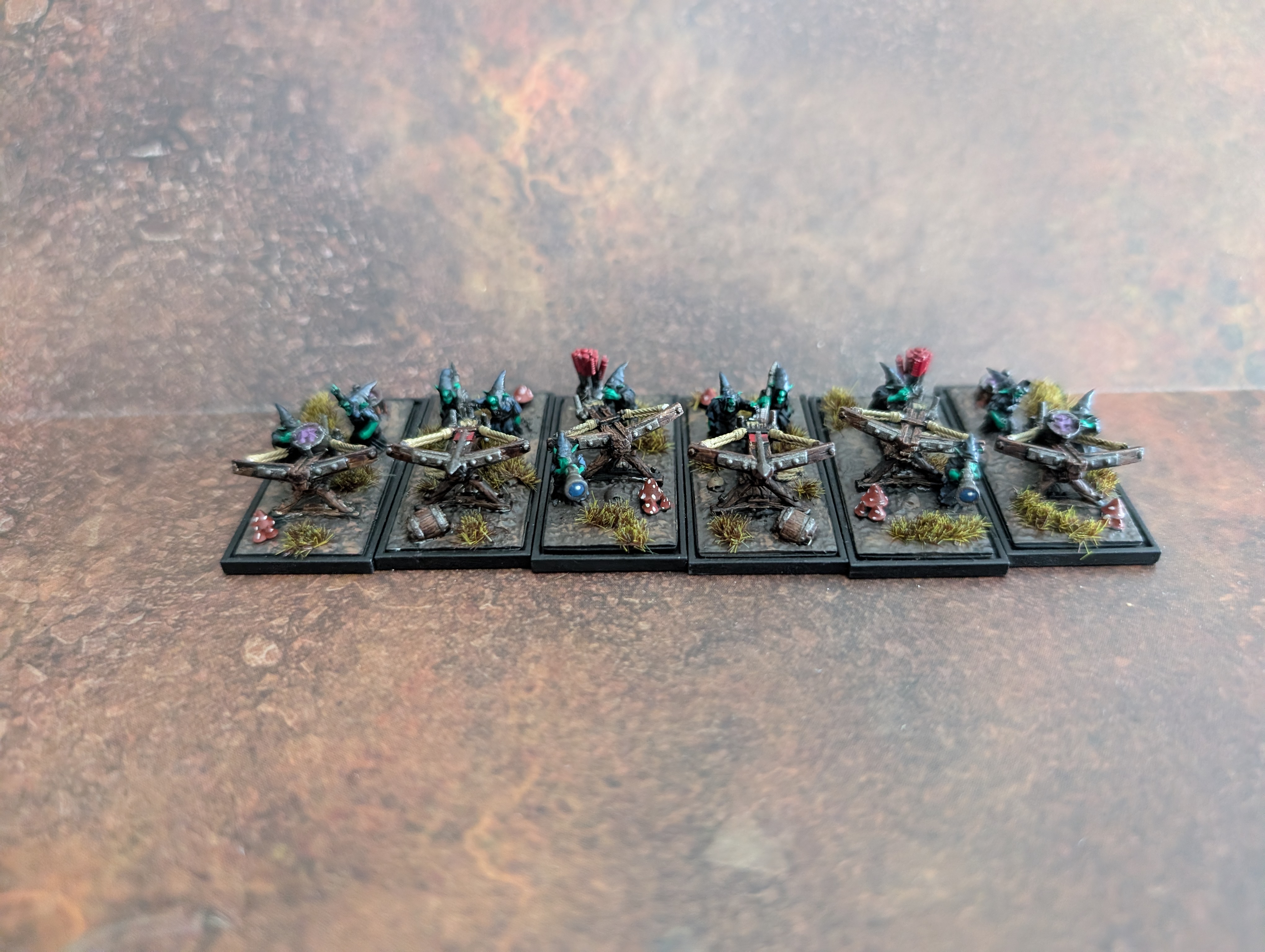 A battery of Warmaster goblin bolt throwers, based up with mushrooms and tufts.