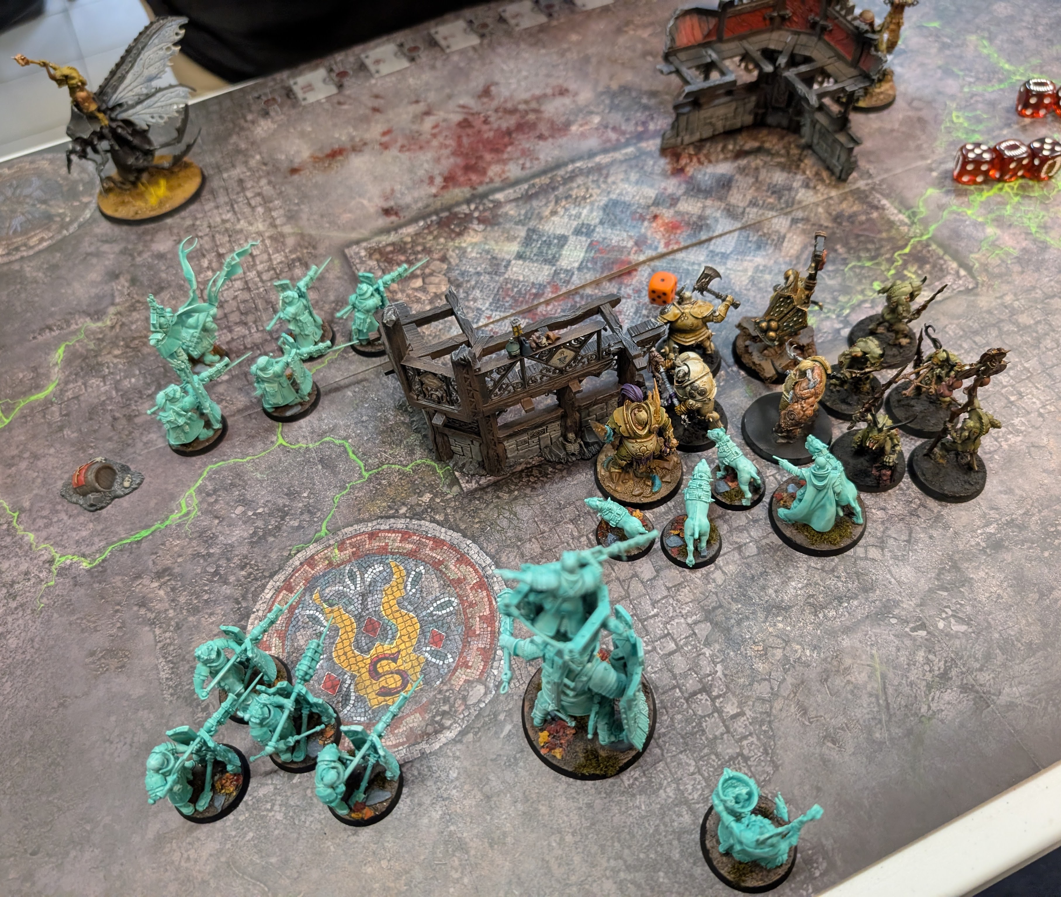 Turquoise Cities of Sigmar troops fight Nurgle warriors around a ruined building, with a winged fly mount behind them.